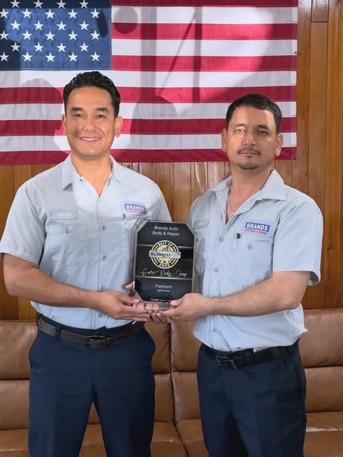 The Brands Auto Body & Repair team holding their Best of Business award for Fremont, California