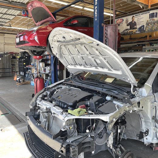 A car up on the lift inside the Brands Auto Body workshop