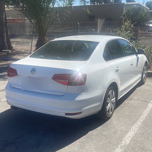A white Volkswagen Jetta after paint work at the shop