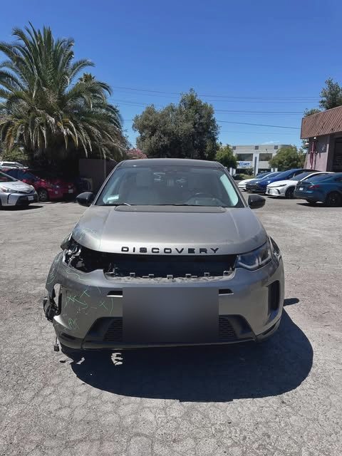 Land Rover Discovery with front bumper and headlight damage awaiting repair